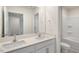 Well lit bathroom featuring double vanity with granite counters, tile floor and tub at 120 Pisgah St, Sanford, NC 27330