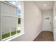 Bright entryway with wood-look floors, a window to the left, and a white front door at 120 Pisgah St, Sanford, NC 27330
