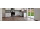 Bright kitchen with white cabinets, stainless steel appliances, and gray backsplash at 120 Pisgah St, Sanford, NC 27330