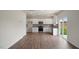 Open kitchen with white cabinets, stainless steel appliances, and slider to backyard at 120 Pisgah St, Sanford, NC 27330