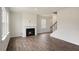 Open floor plan with fireplace, staircase, windows, and wood-look floors at 120 Pisgah St, Sanford, NC 27330