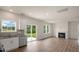 Bright living space featuring wood floors, a fireplace, a door to the back yard, and a kitchen at 120 Pisgah St, Sanford, NC 27330