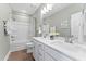 Bathroom featuring double sinks, a bathtub with a shower, and modern fixtures at 1257 S Blount Street # 201, Raleigh, NC 27601