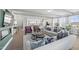 Open-concept living room with exposed beam ceilings, wood flooring, stylish furniture, and seamless access to the kitchen at 1257 S Blount Street # 201, Raleigh, NC 27601