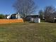 Large backyard featuring green grass, a shed, and a wood fence at 128 Glengariff Ln, Clayton, NC 27520