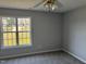 Bright bedroom featuring a ceiling fan, neutral paint, and plush carpet flooring at 128 Glengariff Ln, Clayton, NC 27520