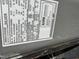 Close-up of the HVAC label showing model and serial number information at 128 Glengariff Ln, Clayton, NC 27520