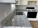 Modern kitchen featuring sleek granite countertops, stainless steel sink, and ample lighting at 128 Glengariff Ln, Clayton, NC 27520