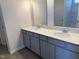 Bathroom with double sink vanity, quartz countertop, and a large mirror at 131 E Victory View. Ter, Smithfield, NC 27577