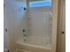 All-white bathtub and shower combo with tiled walls and chrome fixtures at 131 E Victory View. Ter, Smithfield, NC 27577