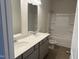 Bathroom featuring double sink vanity, large mirror, and a shower-tub combination at 131 E Victory View. Ter, Smithfield, NC 27577
