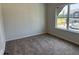 A bedroom with carpeting, neutral walls, and a window with natural light at 131 E Victory View. Ter, Smithfield, NC 27577