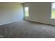 Spacious carpeted bedroom with two windows providing lots of natural light at 131 E Victory View. Ter, Smithfield, NC 27577
