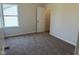 Bright bedroom with plush carpeting, white trim, and a window for natural light, creating a comfortable atmosphere at 131 E Victory View. Ter, Smithfield, NC 27577