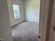 Neutral carpeted bedroom with a window providing natural light and a view at 131 E Victory View. Ter, Smithfield, NC 27577