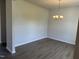 An empty dining room featuring hardwood flooring, neutral paint, and a modern chandelier at 131 E Victory View. Ter, Smithfield, NC 27577