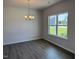 Bright dining area with hardwood floors, modern chandelier, and large window overlooking a view at 131 E Victory View. Ter, Smithfield, NC 27577