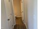 Hallway view leading to a bathroom with tile floors and neutral paint at 131 E Victory View. Ter, Smithfield, NC 27577
