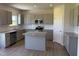 Modern kitchen with gray cabinets, stainless steel appliances, and a center island at 131 E Victory View. Ter, Smithfield, NC 27577