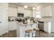 Stylish kitchen with white cabinets, stainless steel appliances, granite countertops, and a kitchen island at 131 E Victory View. Ter, Smithfield, NC 27577