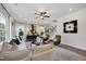 Cozy living room featuring modern decor, hardwood floors, and large windows with natural light at 131 E Victory View. Ter, Smithfield, NC 27577