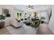 Bright living room with neutral decor, large windows, stylish furniture, and ceiling fan at 131 E Victory View. Ter, Smithfield, NC 27577