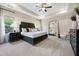 Luxurious bedroom boasts a tray ceiling, plush bedding, and large mirror at 131 E Victory View. Ter, Smithfield, NC 27577