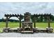 Stone outdoor fireplace surrounded by a pergola-style wood structure at 131 E Victory View. Ter, Smithfield, NC 27577