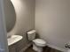 Cozy powder room with a pedestal sink, oval mirror, and tile flooring at 131 E Victory View. Ter, Smithfield, NC 27577