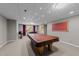 Finished basement with a pool table, foosball table, and carpeted floor, perfect for entertainment at 13121 Sargas St, Raleigh, NC 27614