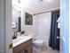 Bright bathroom featuring neutral tones, single sink vanity, and tub with shower and gray curtain at 13121 Sargas St, Raleigh, NC 27614