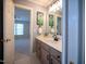 Bathroom with beige vanity, large mirror, and doorway to a bedroom at 13121 Sargas St, Raleigh, NC 27614