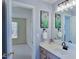 Bathroom with decorative purple floral art, vanity, and a door leading to a bedroom at 13121 Sargas St, Raleigh, NC 27614