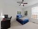 Comfortable bedroom featuring a ceiling fan, window, and small desk at 13121 Sargas St, Raleigh, NC 27614