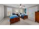 Comfortable bedroom featuring two beds, a ceiling fan, and a built-in desk at 13121 Sargas St, Raleigh, NC 27614