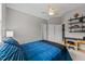 Cozy bedroom features a ceiling fan, built-in shelving and a large closet at 13121 Sargas St, Raleigh, NC 27614