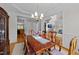 Formal dining room featuring hardwood floors, a large table, and views into other living spaces at 13121 Sargas St, Raleigh, NC 27614