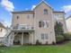 Rear exterior view of a home with a deck, patio, and large backyard at 13121 Sargas St, Raleigh, NC 27614