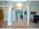 Bright hallway showcasing hardwood floors and an open floor plan leading into the living room at 13121 Sargas St, Raleigh, NC 27614