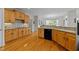 Spacious kitchen with hardwood floors, light wood cabinets, and modern appliances at 13121 Sargas St, Raleigh, NC 27614