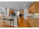 Open kitchen featuring hardwood floors, light wood cabinets, and a breakfast bar with seating at 13121 Sargas St, Raleigh, NC 27614