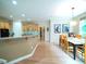 Open-concept kitchen and dining area with wooden cabinets, breakfast bar, and natural light at 13121 Sargas St, Raleigh, NC 27614