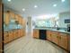 Spacious kitchen features wooden cabinetry, stainless steel appliances, and an adjacent breakfast nook at 13121 Sargas St, Raleigh, NC 27614