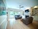 Bright living room with a fireplace, built-in bookshelves, and large windows overlooking the backyard at 13121 Sargas St, Raleigh, NC 27614