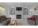 Comfortable living room with built-in shelving, a fireplace, and neutral decor at 13121 Sargas St, Raleigh, NC 27614
