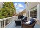 Upper deck with blue cushioned wicker chairs, a fire pit table, and a grill at 13121 Sargas St, Raleigh, NC 27614