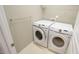 Convenient laundry room with a white, front-load washer and dryer and a chrome towel bar at 136 Sabiston Ct, Cary, NC 27519