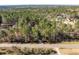 An expansive aerial view of a property surrounded by lush forest and a highway at 1617 Jenkins Rd, Wake Forest, NC 27587