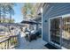Back deck featuring stylish outdoor seating, an umbrella for shade, and a sliding door for indoor/outdoor living at 1617 Jenkins Rd, Wake Forest, NC 27587