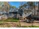 A spacious backyard with mature trees, deck, patio, and gazebo at 1617 Jenkins Rd, Wake Forest, NC 27587